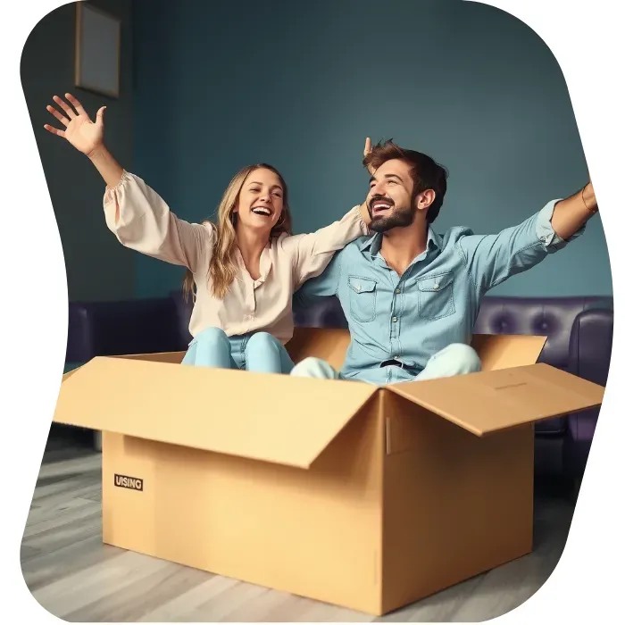 Two guys sitting on the floor of their apartment with Muval moving boxes